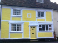 Brightly painted, pargetted cottage in the town centre